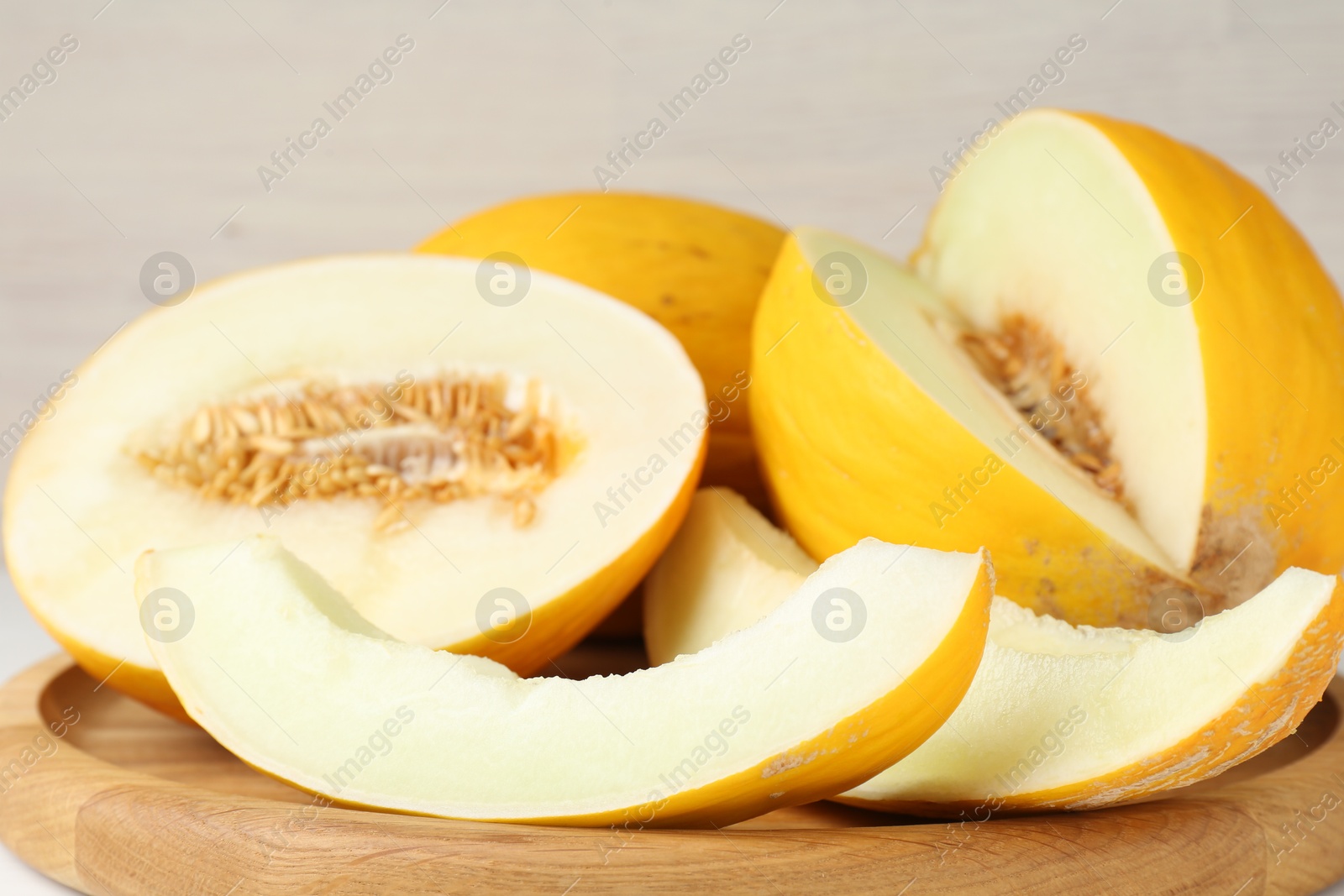 Photo of Fresh ripe melons on wooden board, closeup