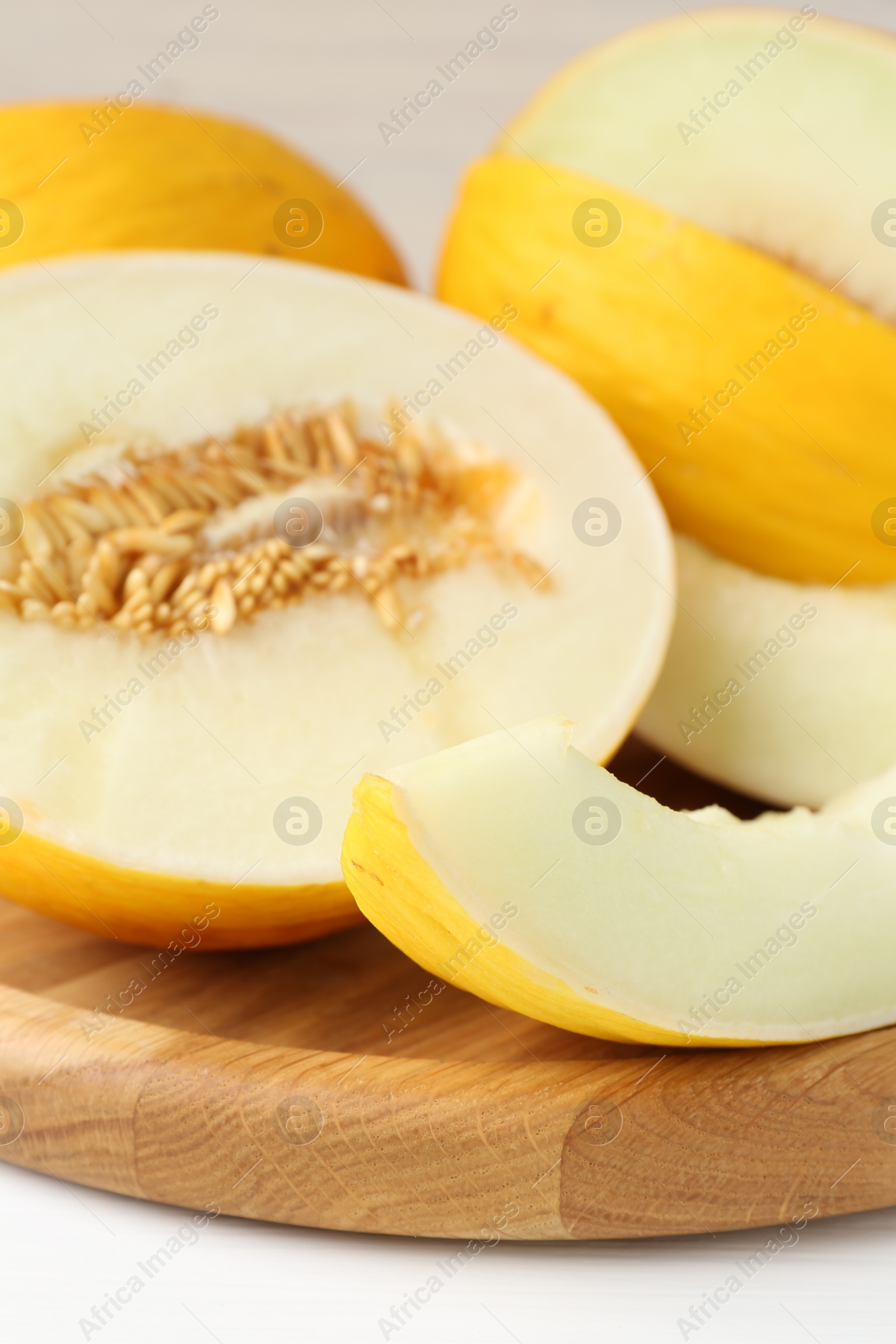 Photo of Fresh ripe melons on white table, closeup