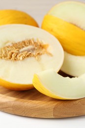 Photo of Fresh ripe melons on white table, closeup