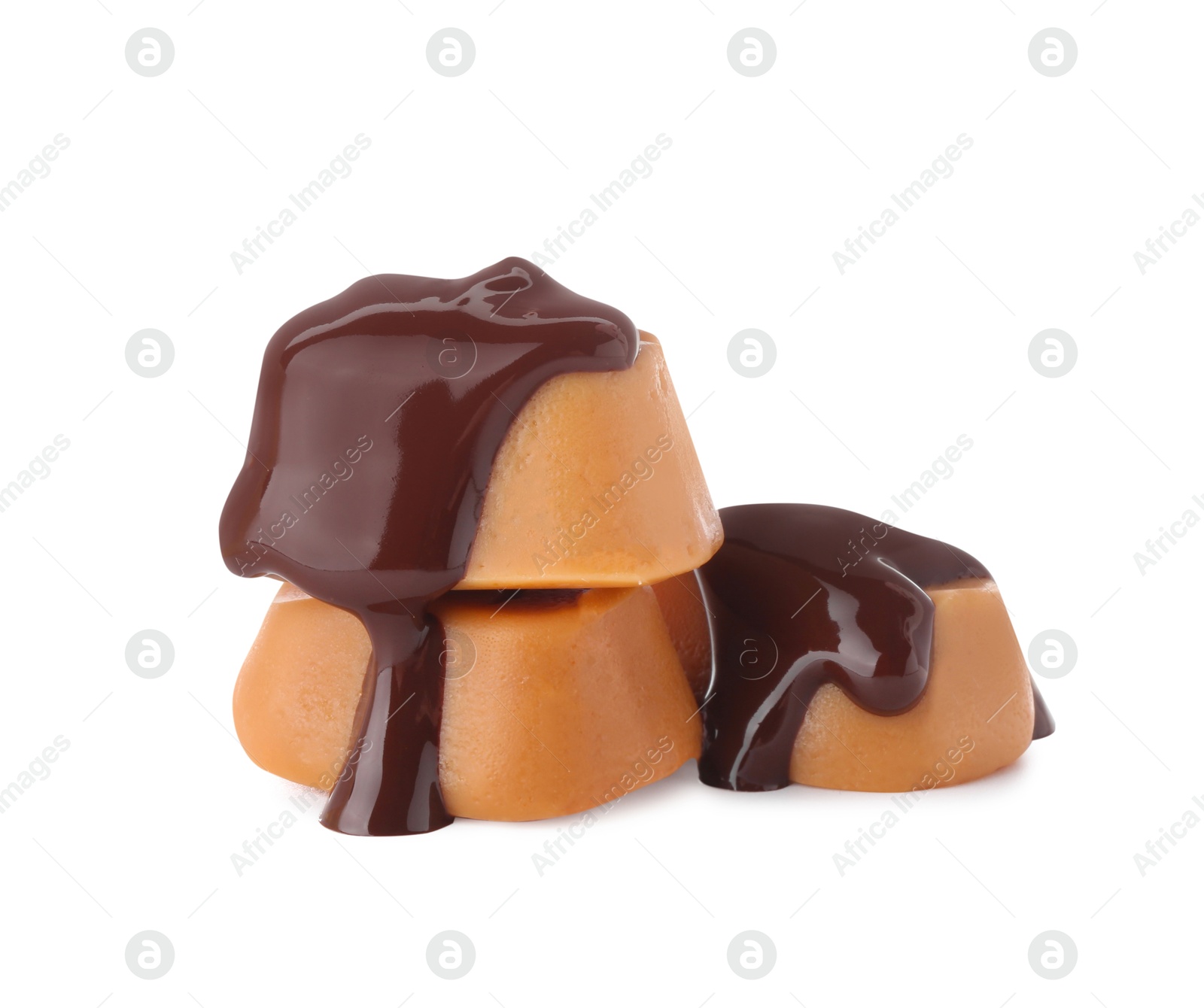 Photo of Delicious caramel candies with melted chocolate isolated on white