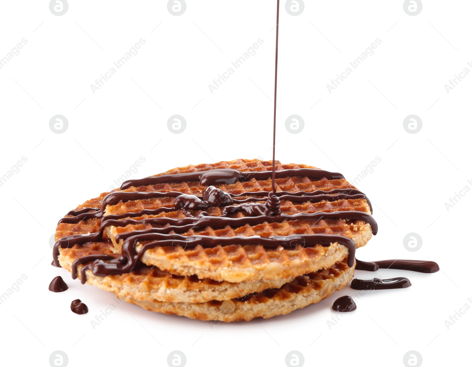 Photo of Pouring melted chocolate onto waffles isolated on white