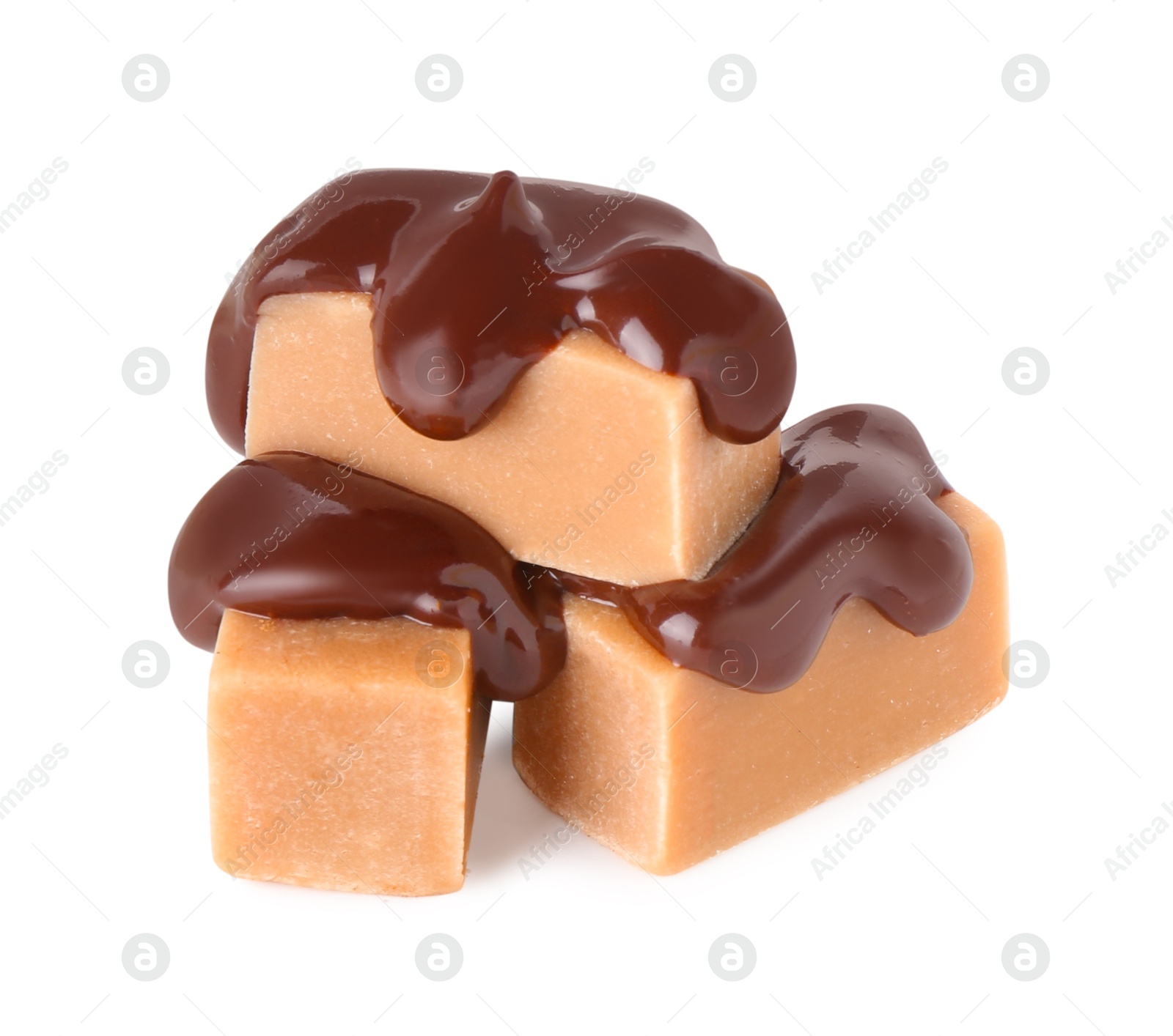 Photo of Tasty caramel candies with melted chocolate isolated on white