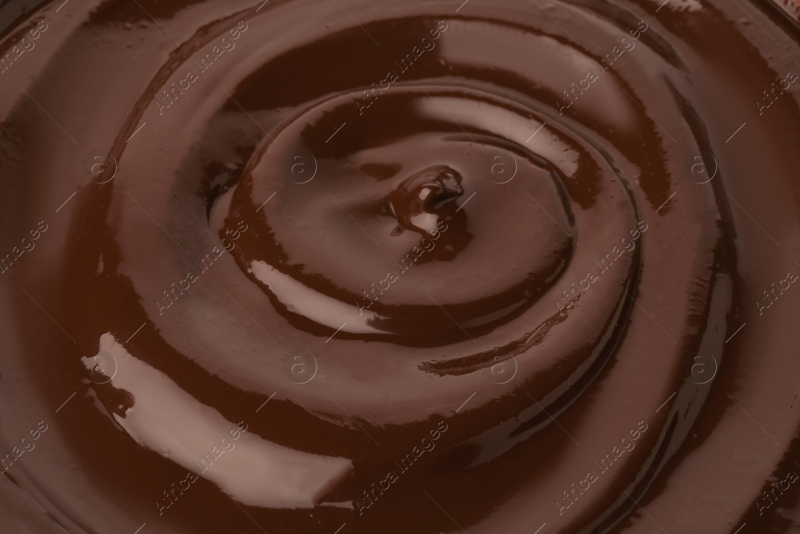 Photo of Tasty melted chocolate as background, closeup view