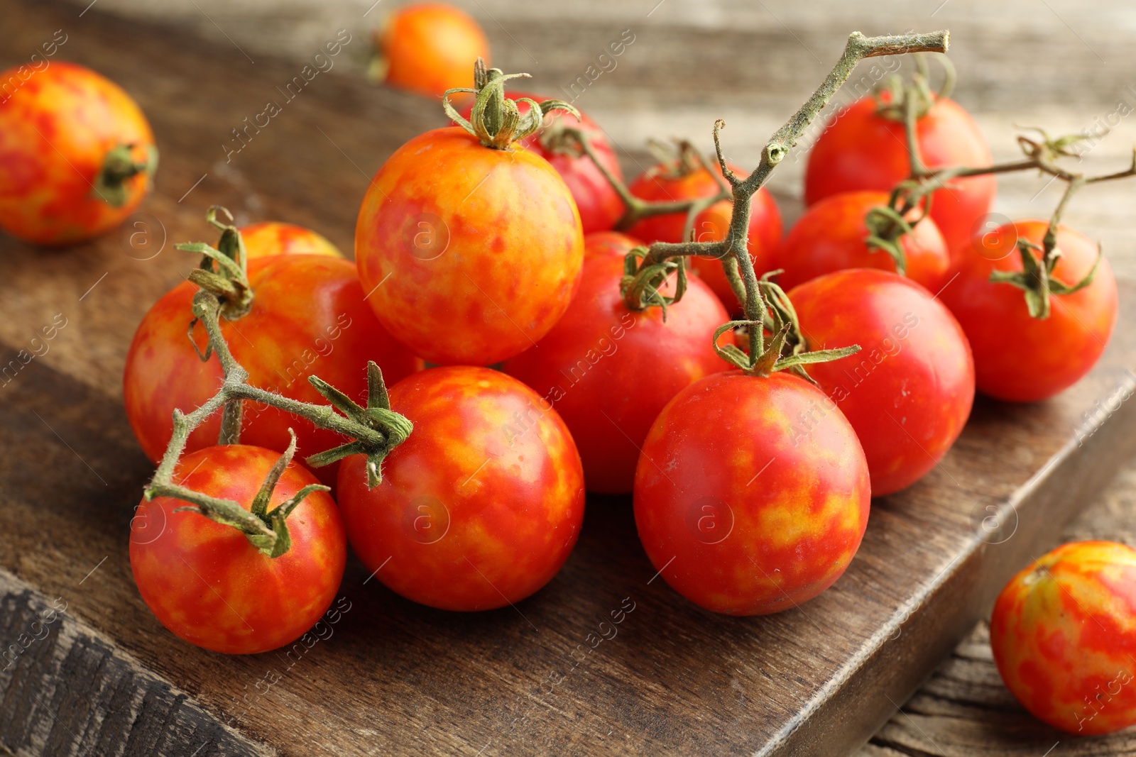 Photo of Fresh ripe tomatoes on wooden table, closeup