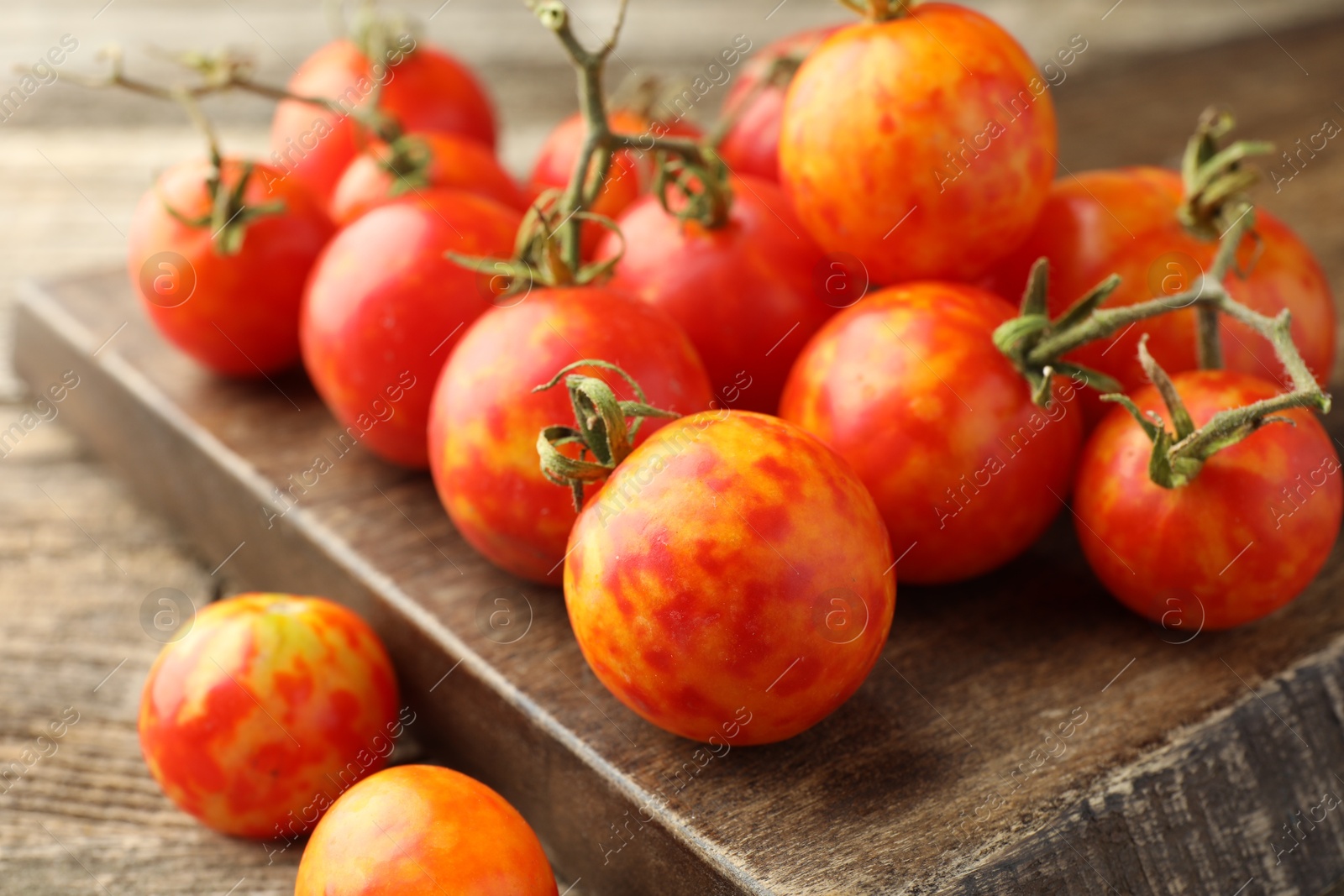 Photo of Fresh ripe tomatoes on wooden table, closeup