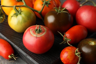 Different ripe tomatoes on grey table, closeup