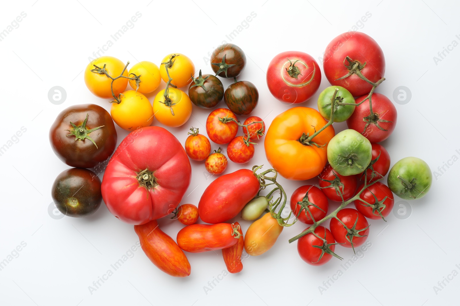 Photo of Different ripe tomatoes on white background, flat lay