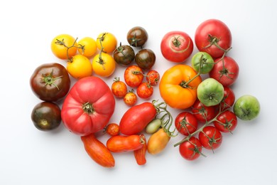 Photo of Different ripe tomatoes on white background, flat lay