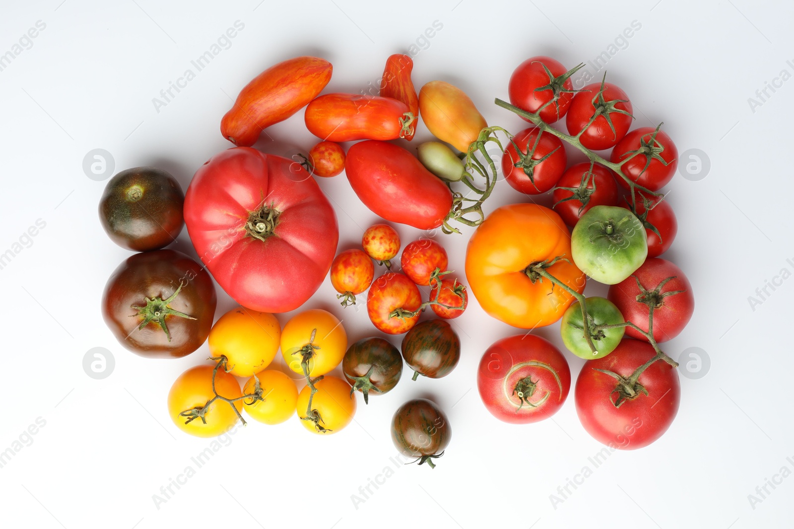 Photo of Different ripe tomatoes on white background, flat lay