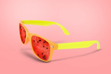 Image of Sunglasses with juicy watermelon in air on pink background. Summer vibe