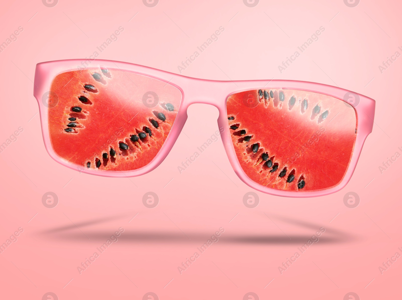 Image of Sunglasses with juicy watermelon in air on pink background. Summer vibe