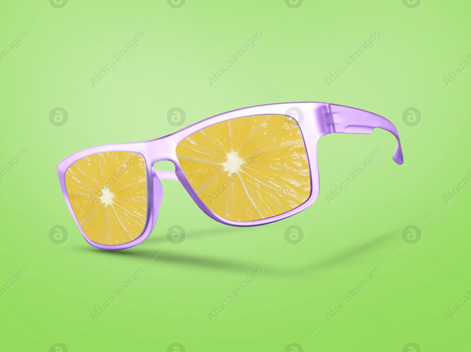 Image of Sunglasses with juicy orange in air on green background. Summer vibe