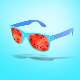 Image of Sunglasses with juicy watermelon in air on light blue background. Summer vibe