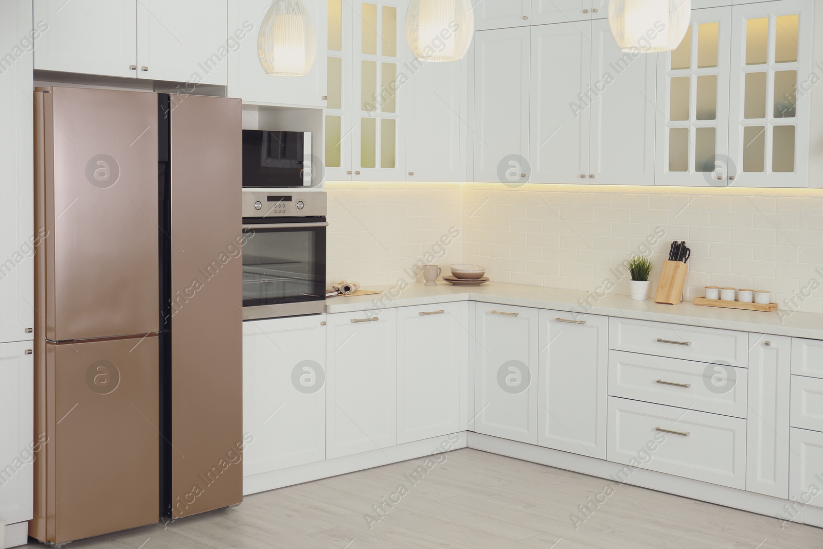 Image of Brown refrigerator in furnished kitchen. Stylish interior