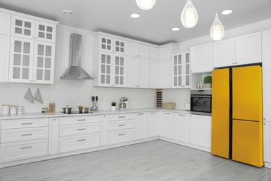 Image of Yellow refrigerator in kitchen. Bright color accent in interior