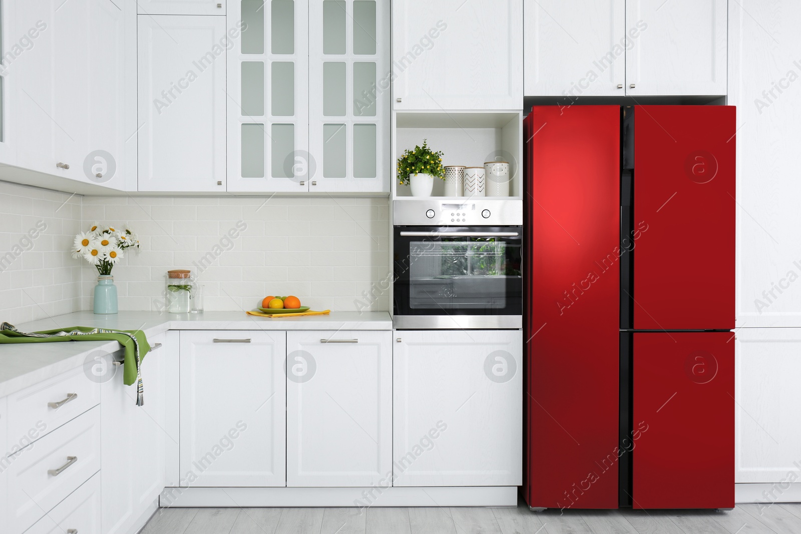 Image of Red refrigerator in kitchen. Bright color accent in interior