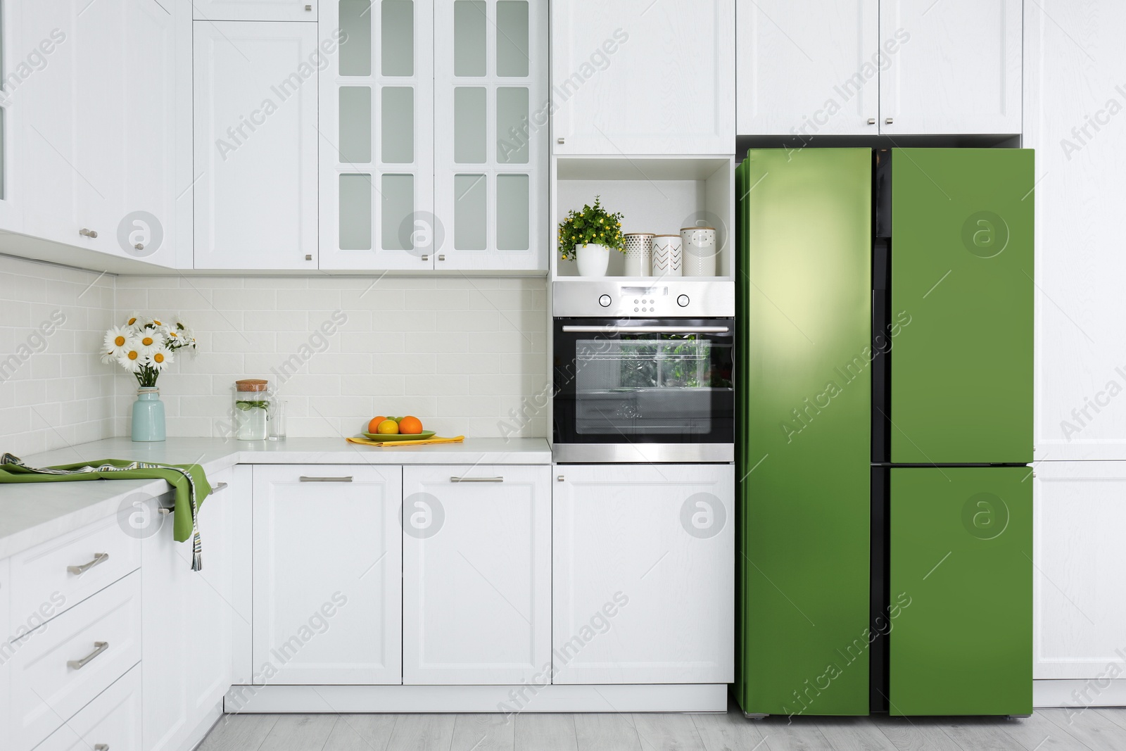 Image of Green refrigerator in kitchen. Bright color accent in interior