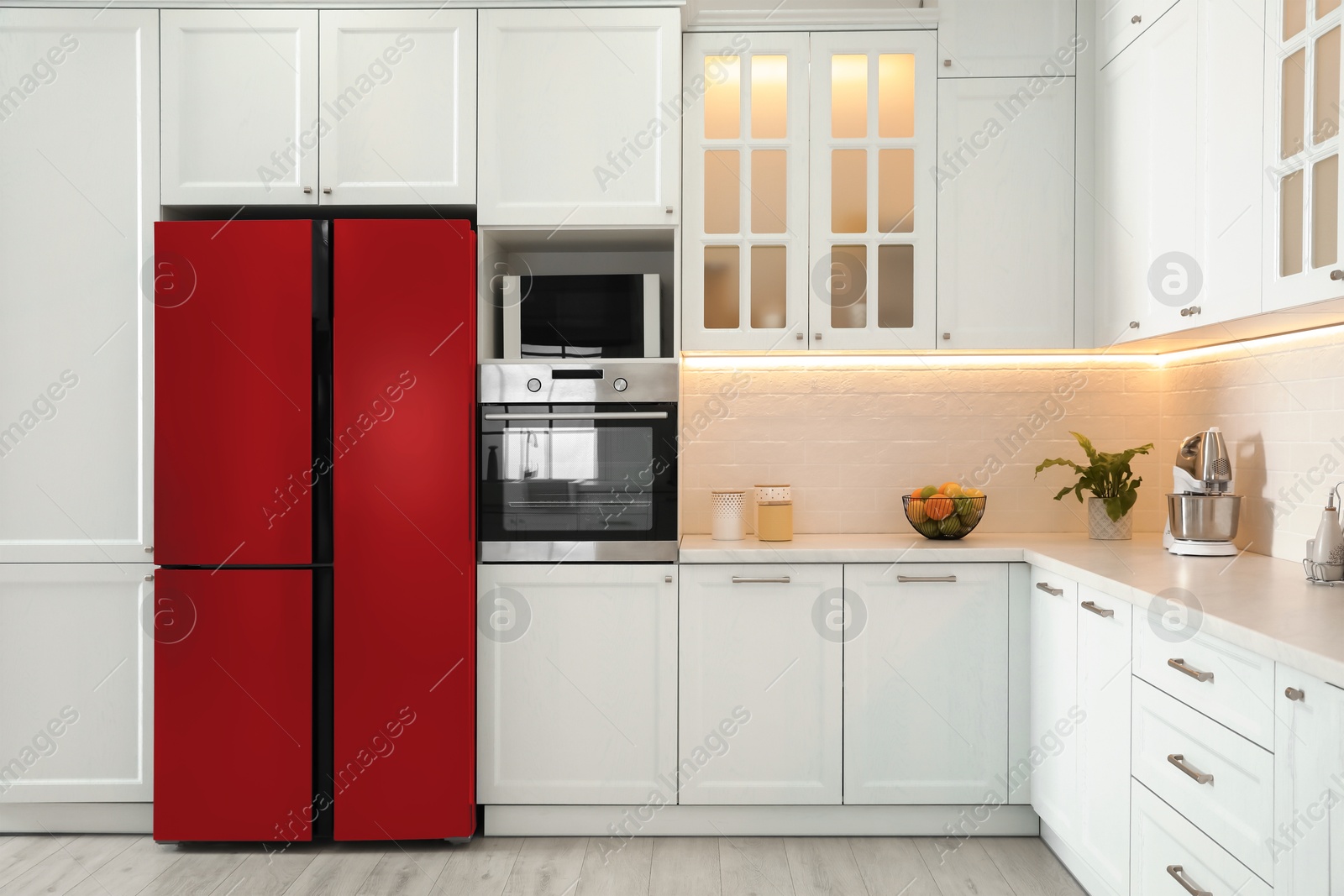 Image of Red refrigerator in kitchen. Bright color accent in interior