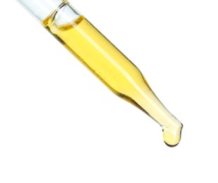 Dripping essential oil from pipette on white background