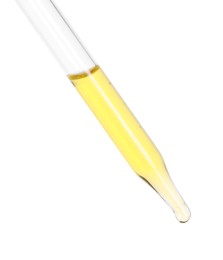 Dripping essential oil from pipette on white background