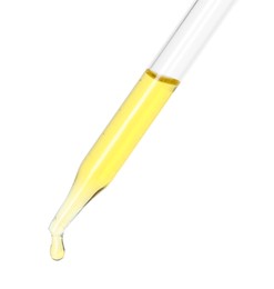 Dripping essential oil from pipette on white background