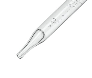 Photo of Dripping cosmetic serum from pipette on white background