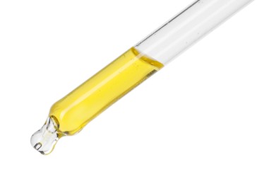 Dripping essential oil from pipette on white background