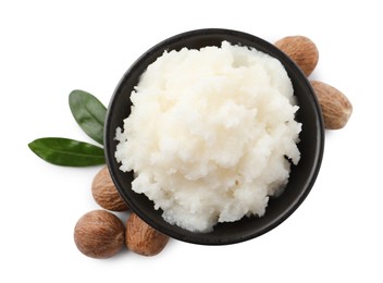 Photo of Natural shea butter in bowl, nuts and green leaves isolated on white, top view