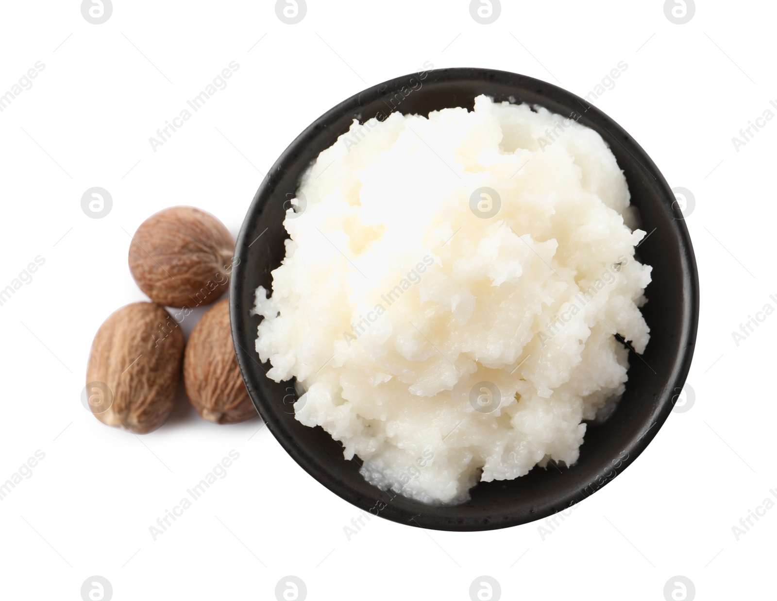 Photo of Natural shea butter in bowl and nuts isolated on white, top view