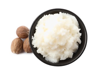 Natural shea butter in bowl and nuts isolated on white, top view