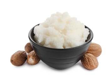 Natural shea butter in bowl and nuts isolated on white