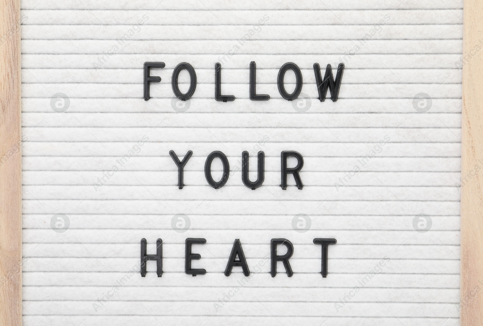 Photo of Letter board with phrase Follow your heart as background, top view