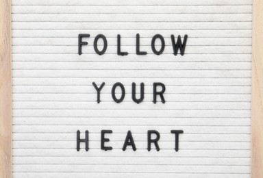 Photo of Letter board with phrase Follow your heart as background, top view