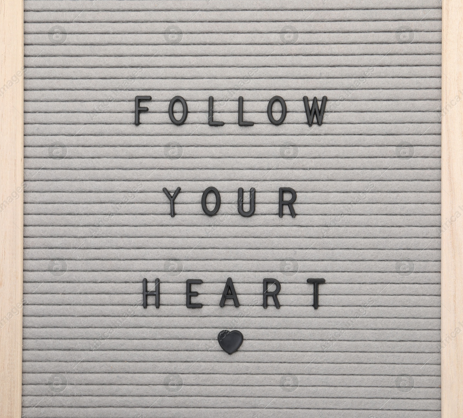 Photo of Letter board with phrase Follow your heart on white background, top view