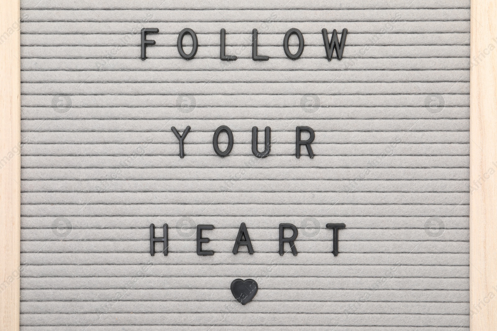 Photo of Letter board with phrase Follow your heart as background, top view