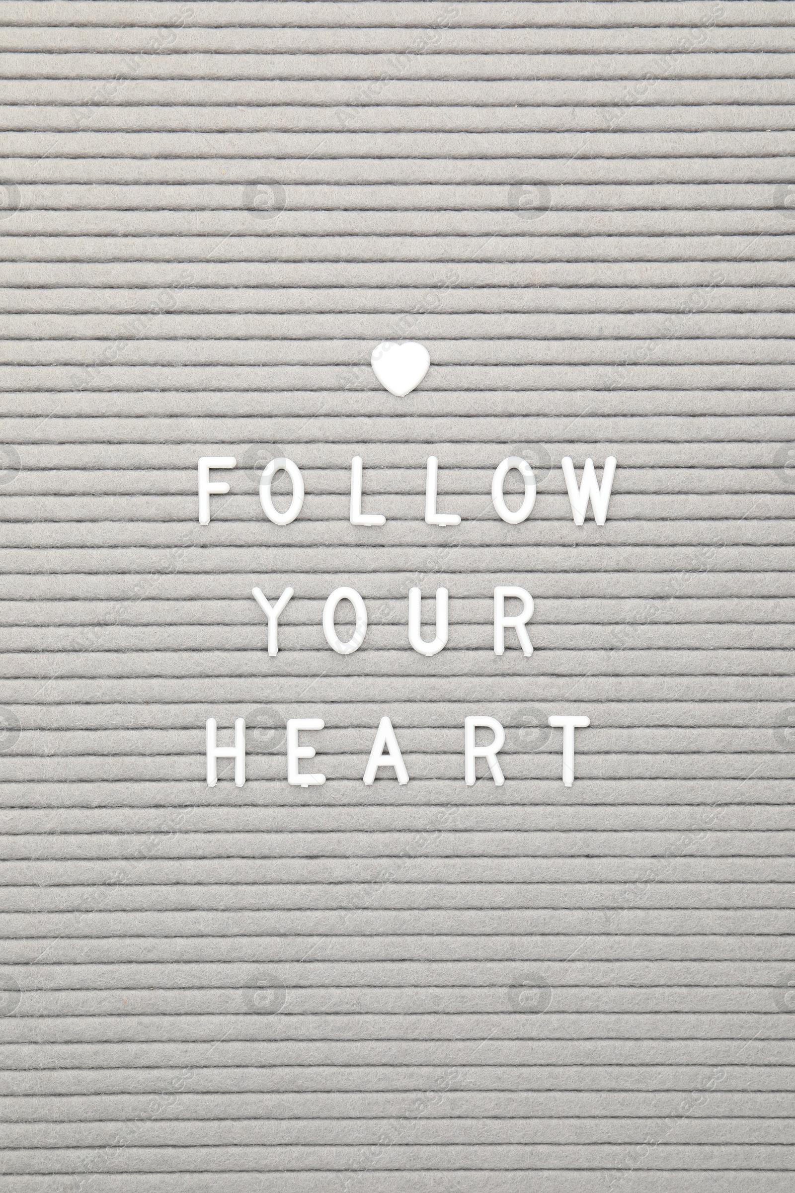 Photo of Letter board with phrase Follow your heart as background, top view