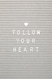 Photo of Letter board with phrase Follow your heart as background, top view