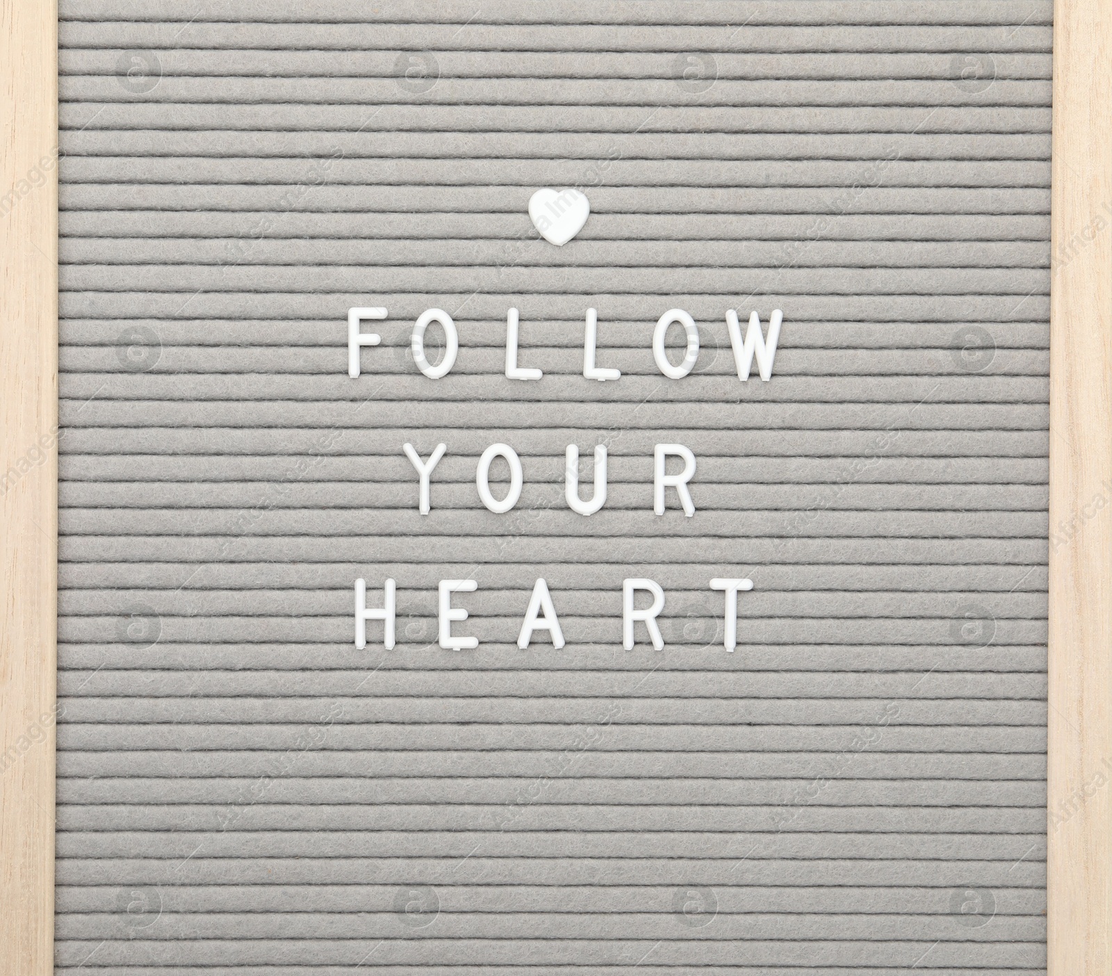 Photo of Letter board with phrase Follow your heart on white background, top view