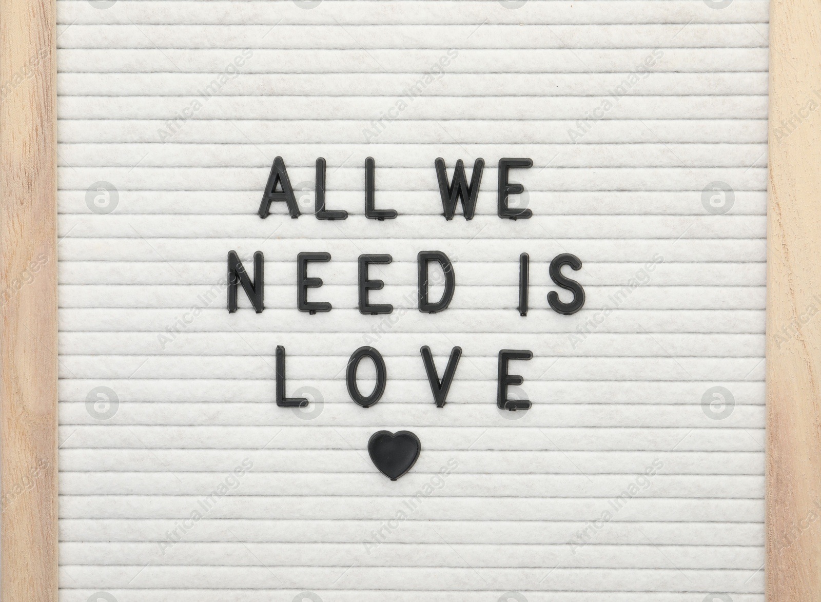 Photo of Letter board with phrase All we need is love on white background, top view