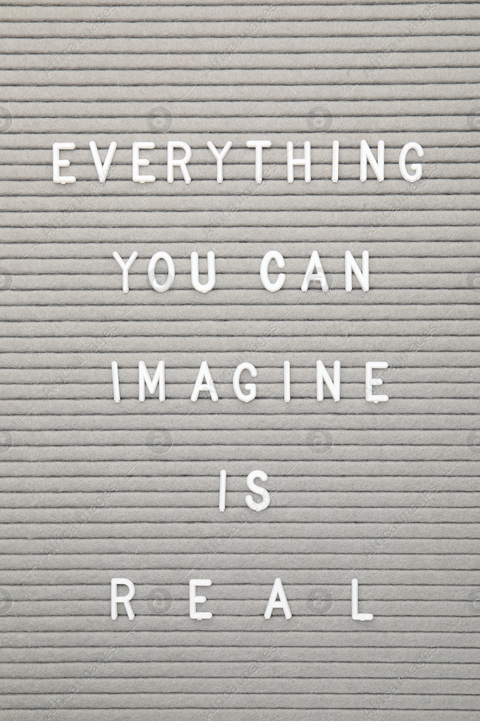 Photo of Letter board with phrase Everything you can imagine is real as background, top view