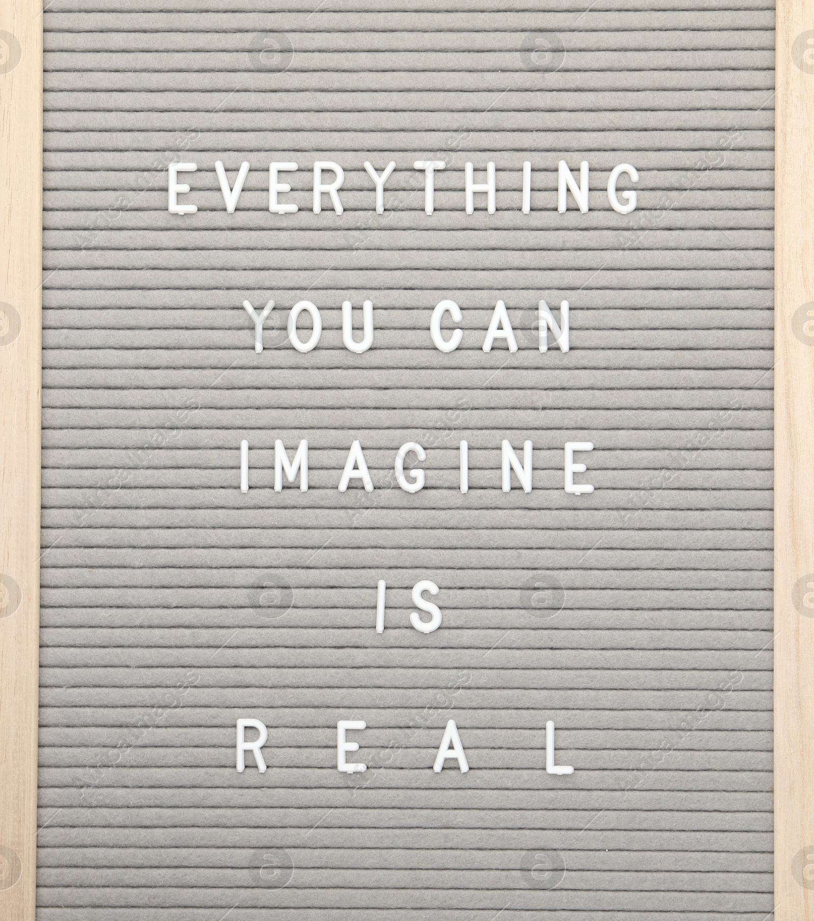 Photo of Letter board with phrase Everything you can imagine is real on white background, top view