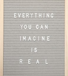 Letter board with phrase Everything you can imagine is real on white background, top view