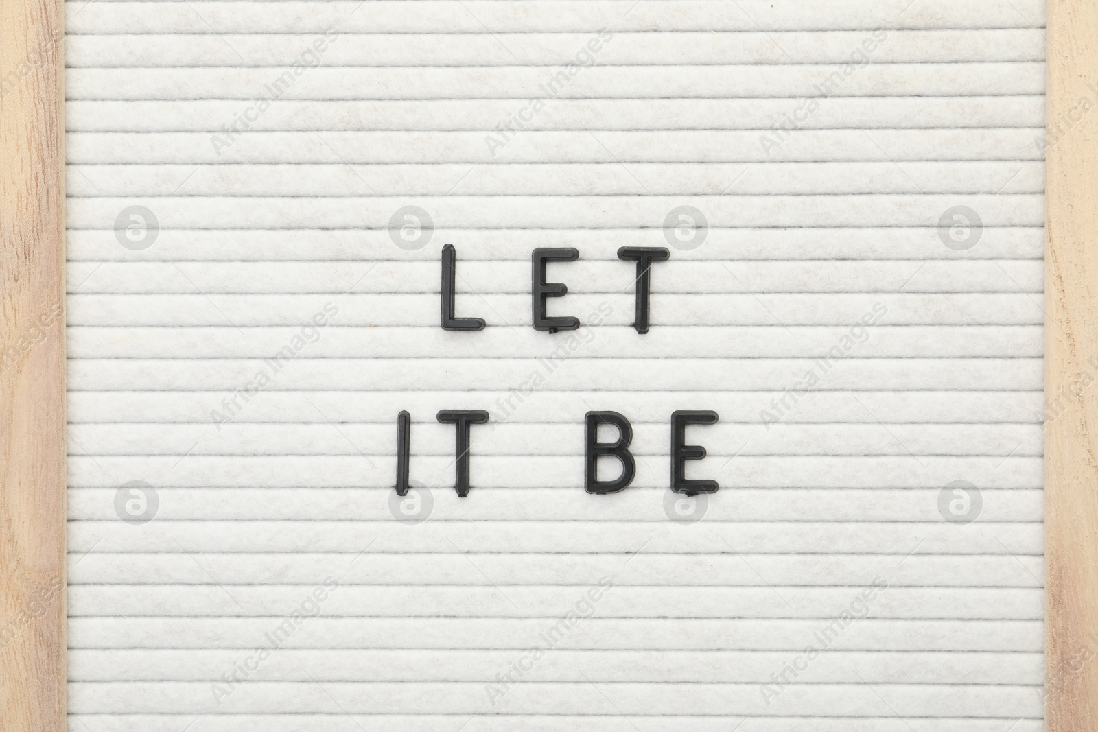 Photo of Letter board with phrase Let it be as background, top view