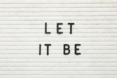 Photo of Letter board with phrase Let it be as background, top view