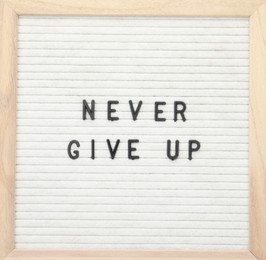 Photo of Letter board with phrase Never give up on white background, top view