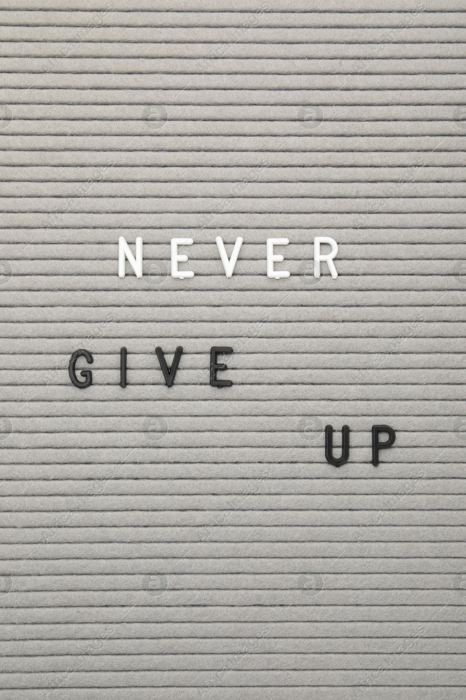 Photo of Letter board with phrase Never give up as background, top view