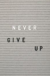 Photo of Letter board with phrase Never give up as background, top view