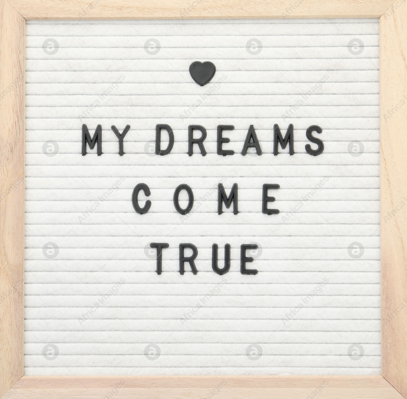 Photo of Letter board with phrase My dreams come true on white background, top view