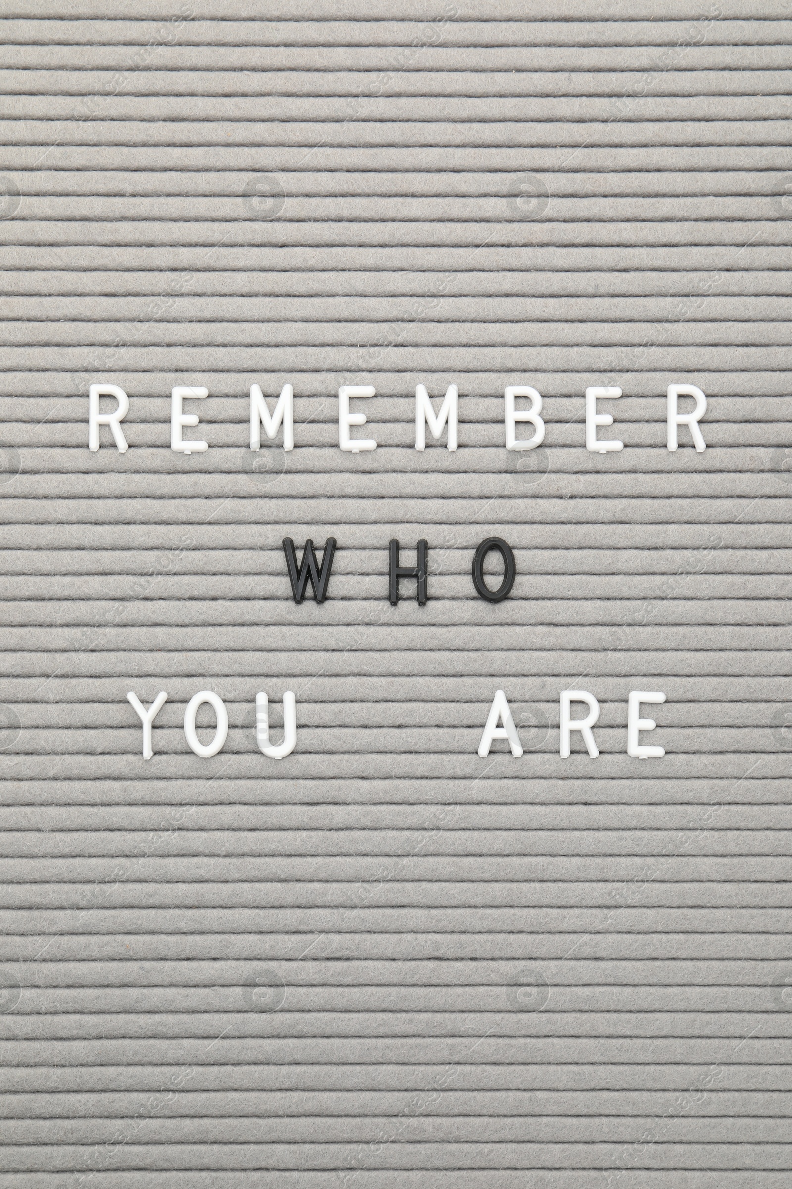 Photo of Letter board with phrase Remember who you are as background, top view