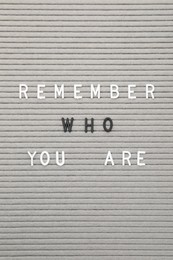 Photo of Letter board with phrase Remember who you are as background, top view